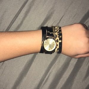 Magnetic watch with gold and cheetah detail.